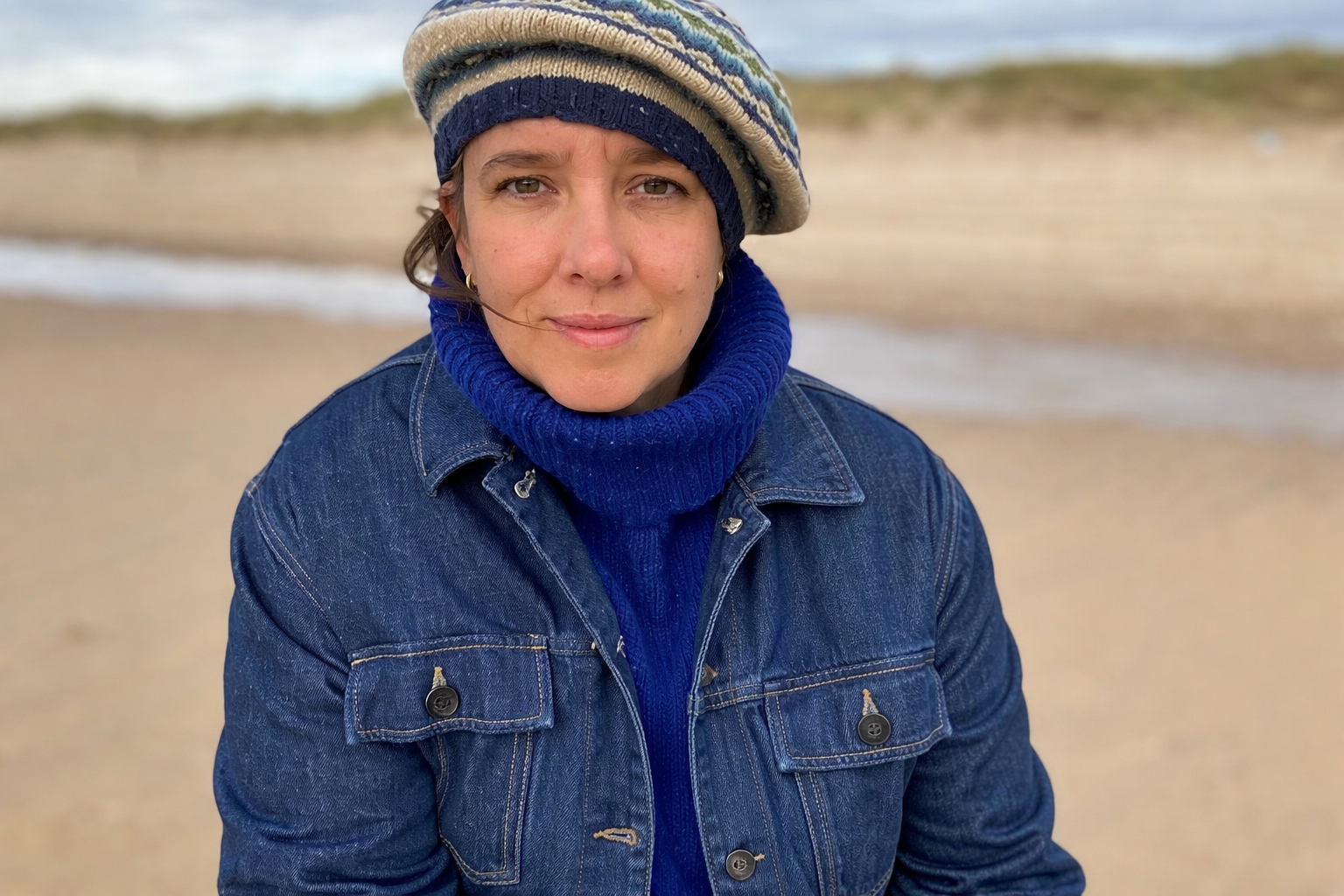 The teacher Maaike van Geijn wearing a knitted sweater and hat.